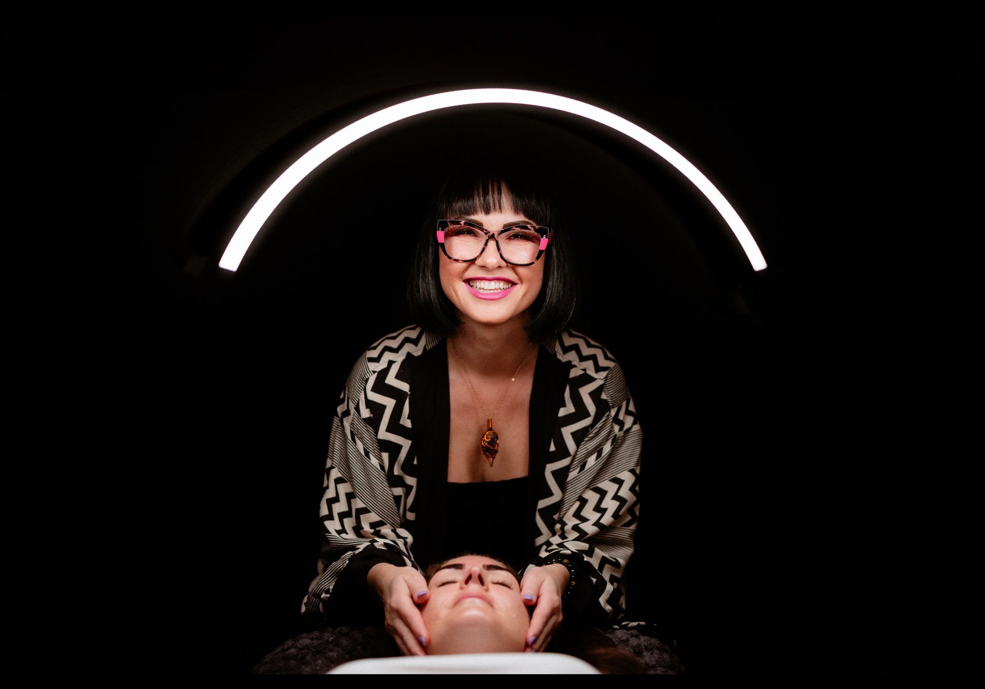 Kasia under the arc light in her treatment room