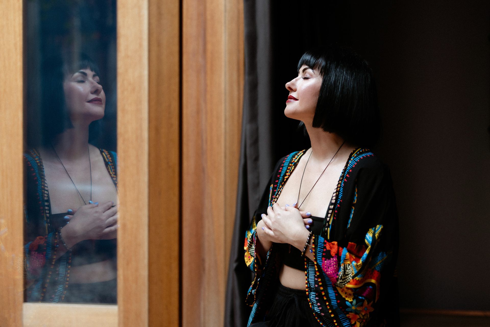 Kasia standing by the timber window at Vitality House